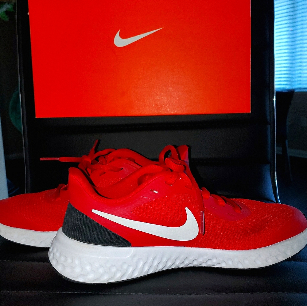 Junior's Red and White Nike Revolutions Trainers.